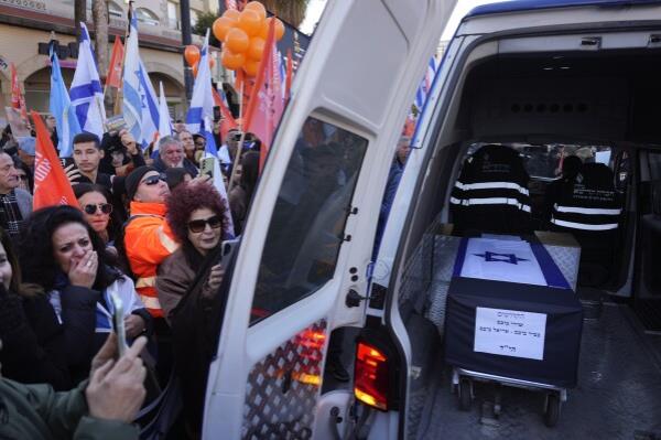 Mourners gather around the car carrying the coffins of slain hostages Shiri Bibas and her two children, Ariel and Kfir, during their funeral procession in Rishon Lezion, Israel, Wednesday, Feb. 26, 2025. The mother and her two children were abducted by Hamas on Oct. 7, 2023, and their remains were returned from Gaza to Israel last week as part of a ceasefire agreement with Hamas. (AP Photo/Ariel Schalit)