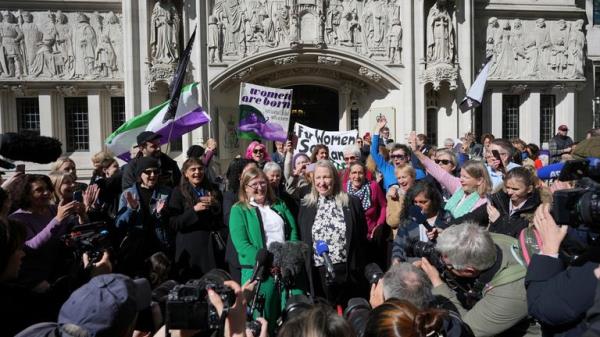 Marion Calder and Susan Smith from For Women Scotland, celebrate outside the Supreme Court to challenge gender recognition laws, in London, Wednesday, April 16, 2025. (AP Photo/Kin Cheung)