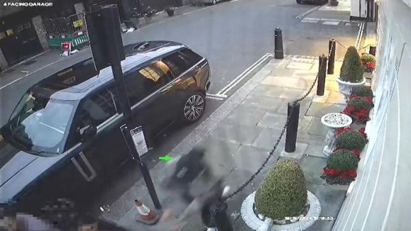 The female officer disappears out of shot as Harket attempts to steal her fake watch