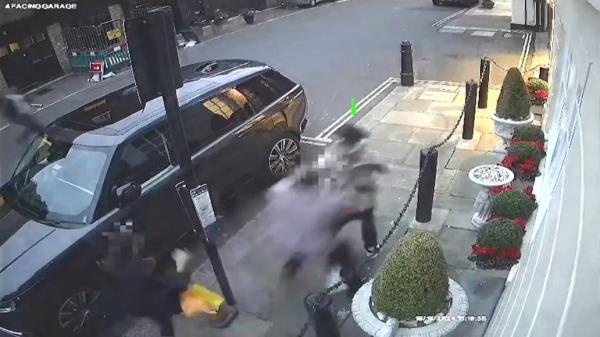 The male officer grabs Harket as the suspect tries to run away. Pic: Met Police
