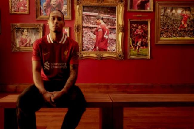 Virgil van Dijk poses with pictures of himself during his Liverpool career