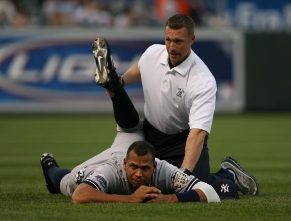 Alex Rodriguez stretches with strength and co<em></em>nditioning coordinator Dana Cavalea before the Baltimore Orioles' 6-0 win over the visiting New York Yankees at Camden Yards on April 19. 2008.