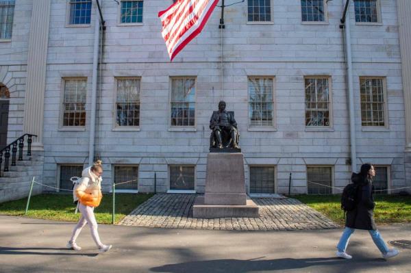 People walk through Harvard Yard at Harvard University in Cambridge, Massachusetts, on Dec 12, 2023. - (Photo by Joseph Prezioso / AFP)