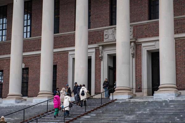 People enter and exit the Harry Elkins Widener Memorial Library on the Harvard University campus in Cambridge, Massachussetts, on April 15, 2025. - (Photo by Joseph Prezioso / AFP)