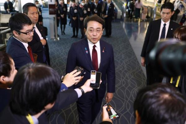 Japan's chief trade negotiator and Eco<em></em>nomic Revitalization Minister Ryosei Akazawa, center, speaks to the reporters before this departure for the U.S., at Haneda airport in Tokyo, Wednesday, April 16, 2025. 
